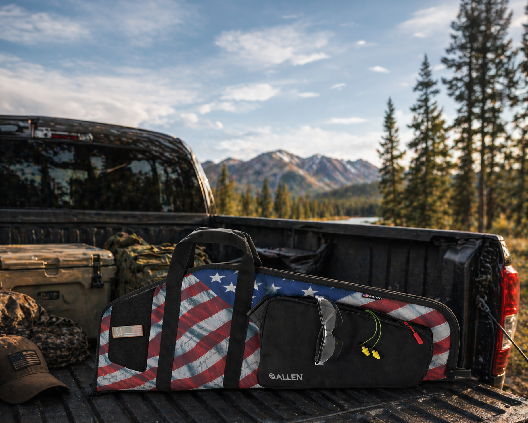 American flag-patterned duffel bag on a truck bed with a scenic background